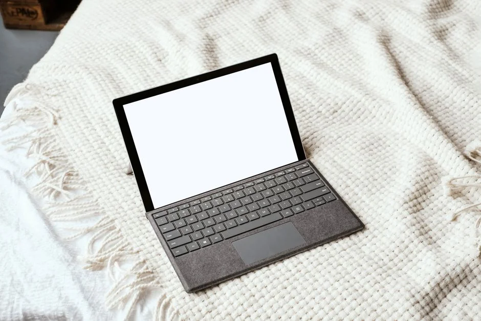 A modern workspace with a smartphone displaying a screen and a computer setup, ideal for business and technology themes.